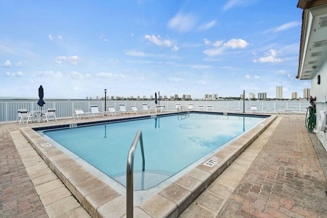 pool featuring a city view and a patio