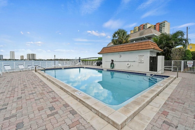 community pool featuring a patio and fence