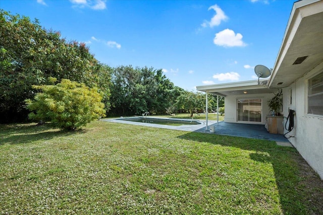 view of yard with an outdoor pool and a patio area