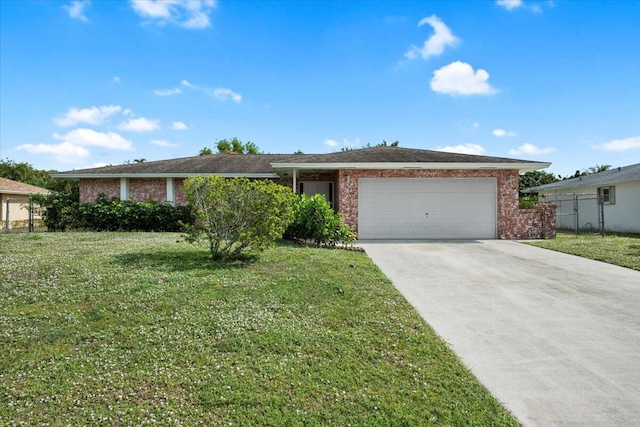 ranch-style house featuring a front lawn, brick siding, a garage, and driveway