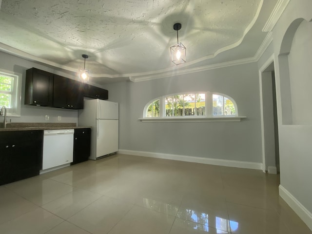 kitchen with white appliances, light tile patterned floors, baseboards, and ornamental molding