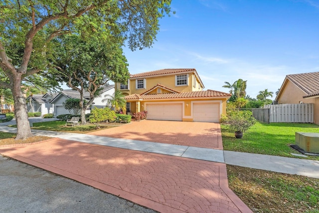 view of front of property with fence, driveway, stucco siding, a garage, and a tiled roof