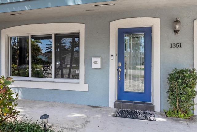 doorway to property with stucco siding