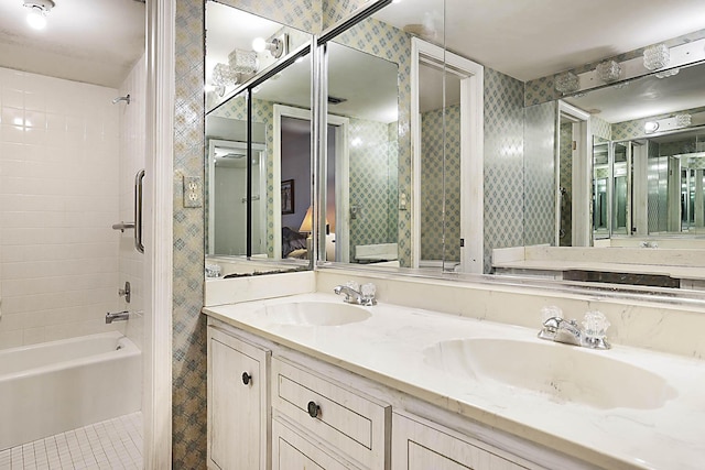 bathroom featuring bathtub / shower combination, double vanity, ensuite bathroom, and a sink