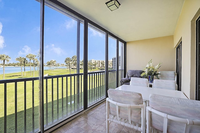 sunroom / solarium with a water view