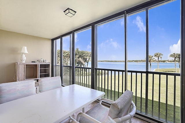 sunroom / solarium with a water view