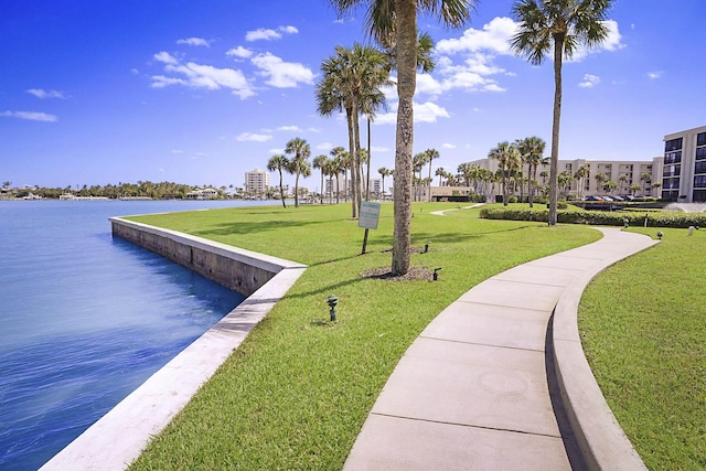 view of community featuring a lawn and a water view