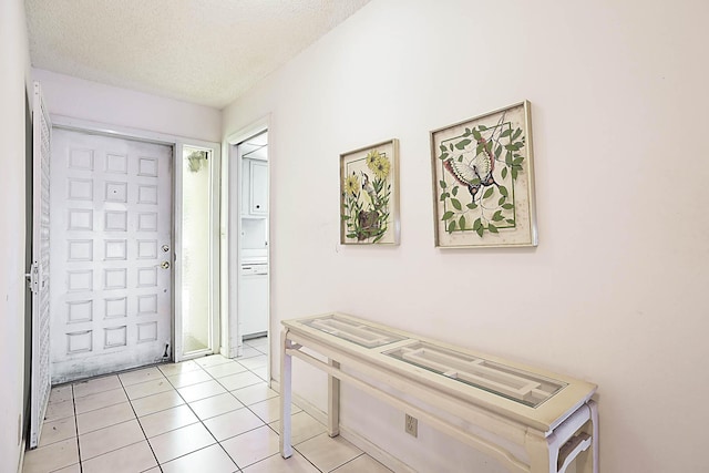 entrance foyer featuring light tile patterned floors and a textured ceiling