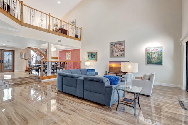 living room featuring baseboards, stairway, french doors, a high ceiling, and marble finish floor