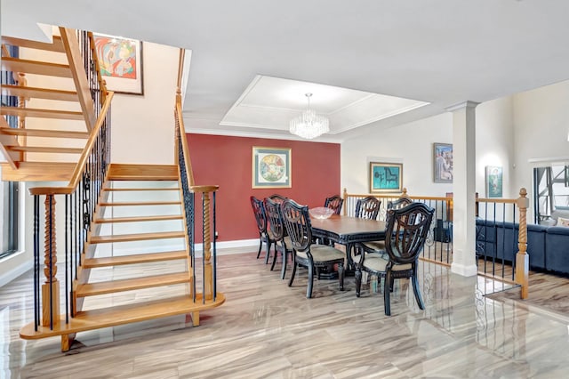 dining room featuring a raised ceiling, a notable chandelier, ornamental molding, stairway, and baseboards