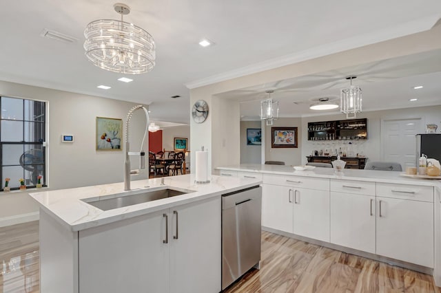 kitchen featuring light stone countertops, dishwasher, pendant lighting, white cabinets, and a kitchen island with sink