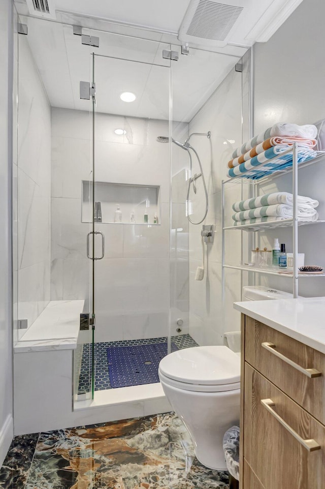 full bath featuring visible vents, vanity, toilet, and a shower stall