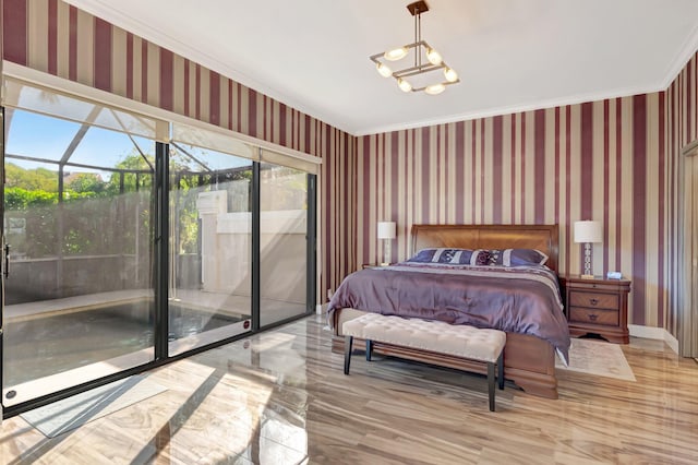 bedroom with access to outside, an inviting chandelier, crown molding, wallpapered walls, and baseboards