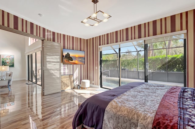 bedroom with wallpapered walls, a sunroom, baseboards, and access to outside