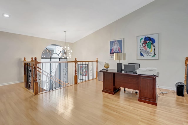 office area featuring a chandelier, light wood-type flooring, baseboards, and ornamental molding