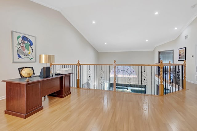 office featuring vaulted ceiling, crown molding, light wood-style floors, and baseboards