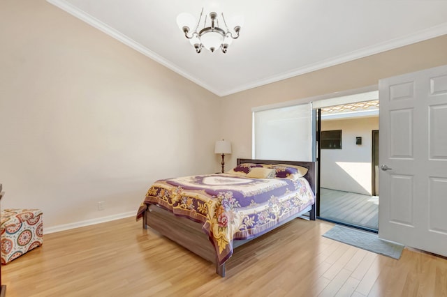 bedroom featuring baseboards, a notable chandelier, ornamental molding, and light wood finished floors