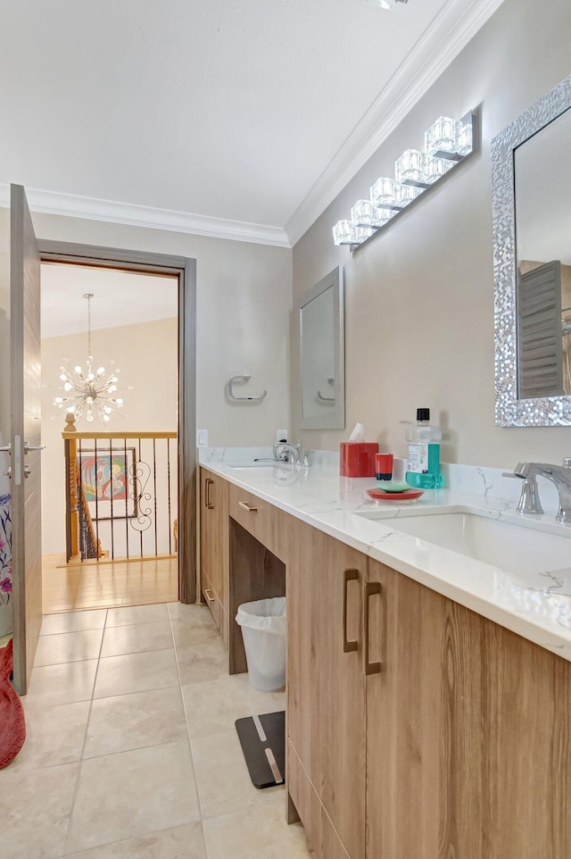 full bathroom with tile patterned flooring, crown molding, double vanity, a notable chandelier, and a sink