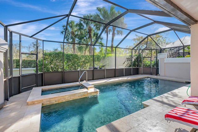 outdoor pool with a lanai, an in ground hot tub, and a patio