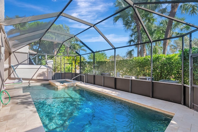 view of swimming pool with a patio area, glass enclosure, and a pool with connected hot tub