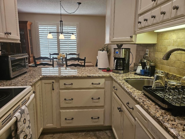 kitchen featuring tasteful backsplash, a textured ceiling, white appliances, a peninsula, and a toaster