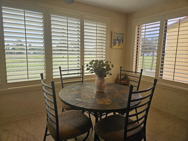 dining space featuring a textured wall