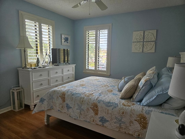 bedroom with a textured ceiling, a ceiling fan, and wood finished floors