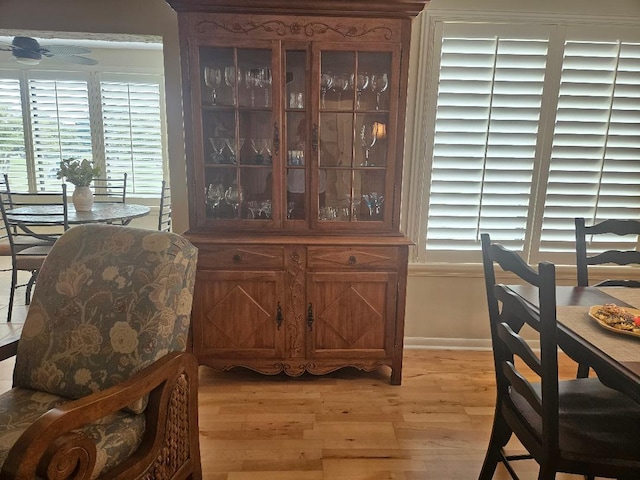 dining space with baseboards, a healthy amount of sunlight, and light wood-style flooring