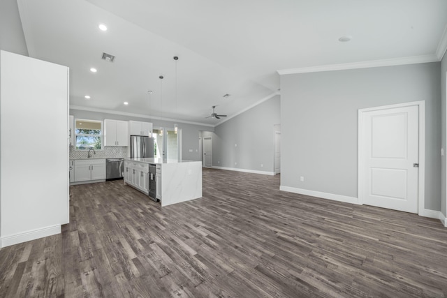 kitchen featuring visible vents, a kitchen island, ceiling fan, open floor plan, and stainless steel appliances