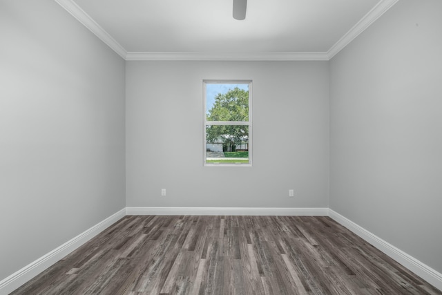 empty room featuring crown molding, dark wood-type flooring, and baseboards