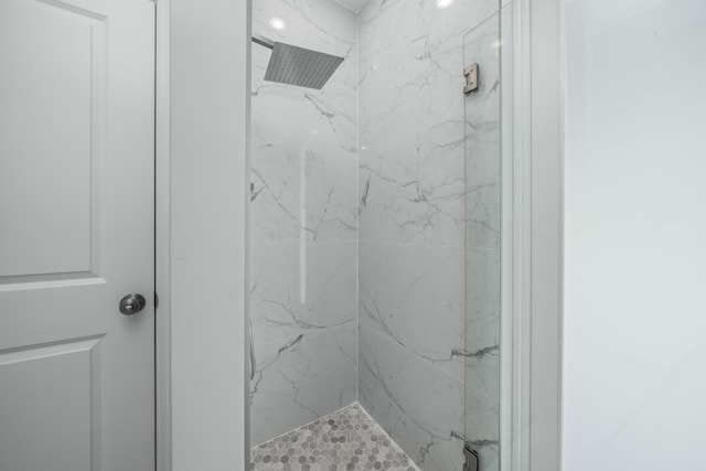 full bath featuring a marble finish shower