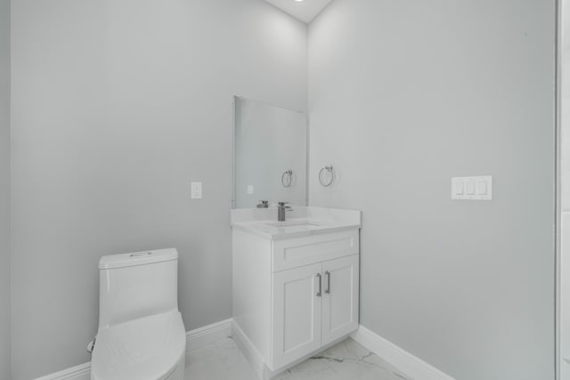 bathroom with baseboards, toilet, marble finish floor, and vanity