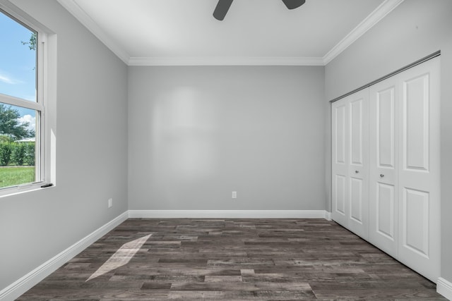 unfurnished bedroom featuring crown molding, baseboards, and dark wood-style flooring