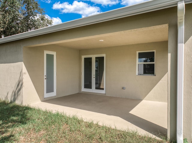 back of property featuring a patio area, stucco siding, and french doors