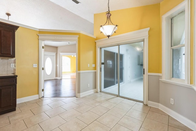 interior space featuring light tile patterned floors and baseboards