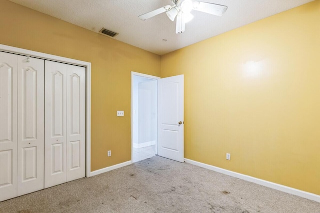 unfurnished bedroom featuring a closet, visible vents, baseboards, and carpet floors