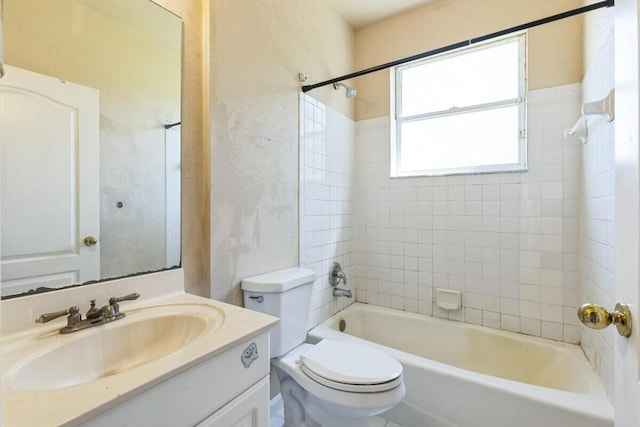 bathroom with vanity, shower / tub combination, toilet, and a textured wall