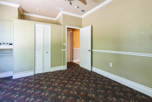 unfurnished bedroom featuring visible vents, ornamental molding, baseboards, and carpet floors