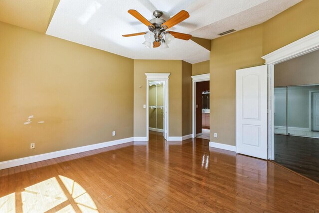 interior space featuring visible vents, wood finished floors, a closet, baseboards, and a spacious closet