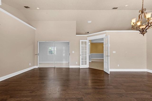 interior space with baseboards, visible vents, dark wood-type flooring, french doors, and a chandelier