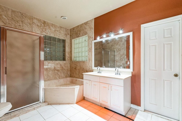 bathroom with a stall shower, vanity, and tile patterned flooring