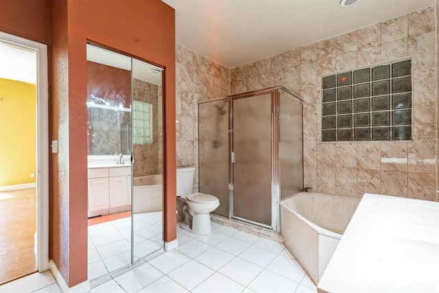 full bathroom with toilet, a stall shower, tile patterned flooring, a bath, and vanity