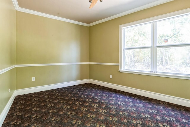 unfurnished room featuring dark carpet, baseboards, and ornamental molding