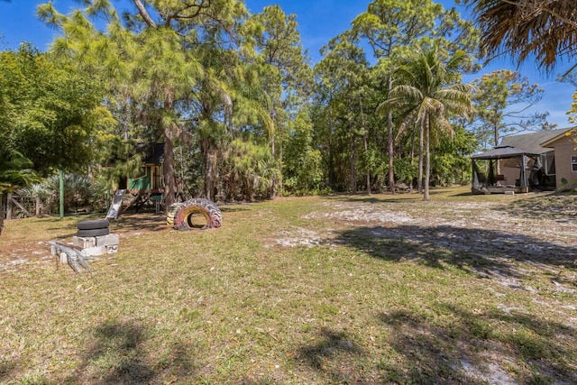 view of yard featuring a gazebo and a playground