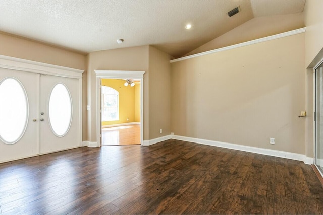 entrance foyer with visible vents, lofted ceiling, dark wood-style floors, and french doors