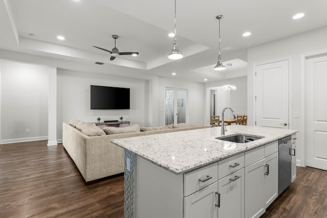 kitchen with dishwasher, a raised ceiling, dark wood-style flooring, and a sink