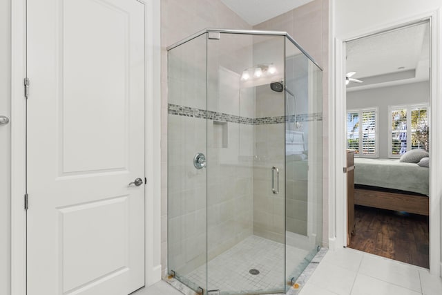 ensuite bathroom featuring tile patterned floors, ensuite bathroom, and a shower stall