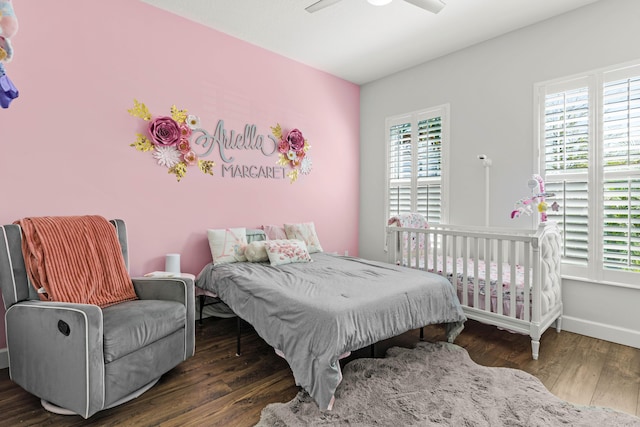 bedroom with multiple windows, wood finished floors, baseboards, and ceiling fan