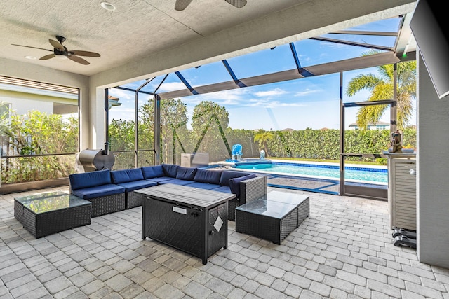 view of patio with a lanai, a fenced in pool, outdoor lounge area, and ceiling fan