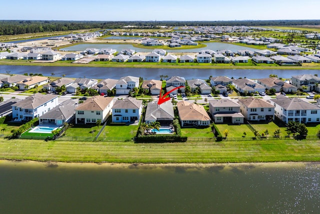 drone / aerial view with a residential view and a water view